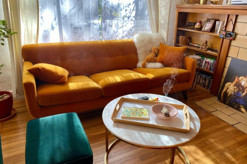 Cozy sustainable living room on a budget with thrifted furniture and plants